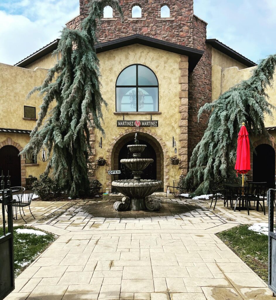 Mediterranean-style building with central fountain and terrace seating.
