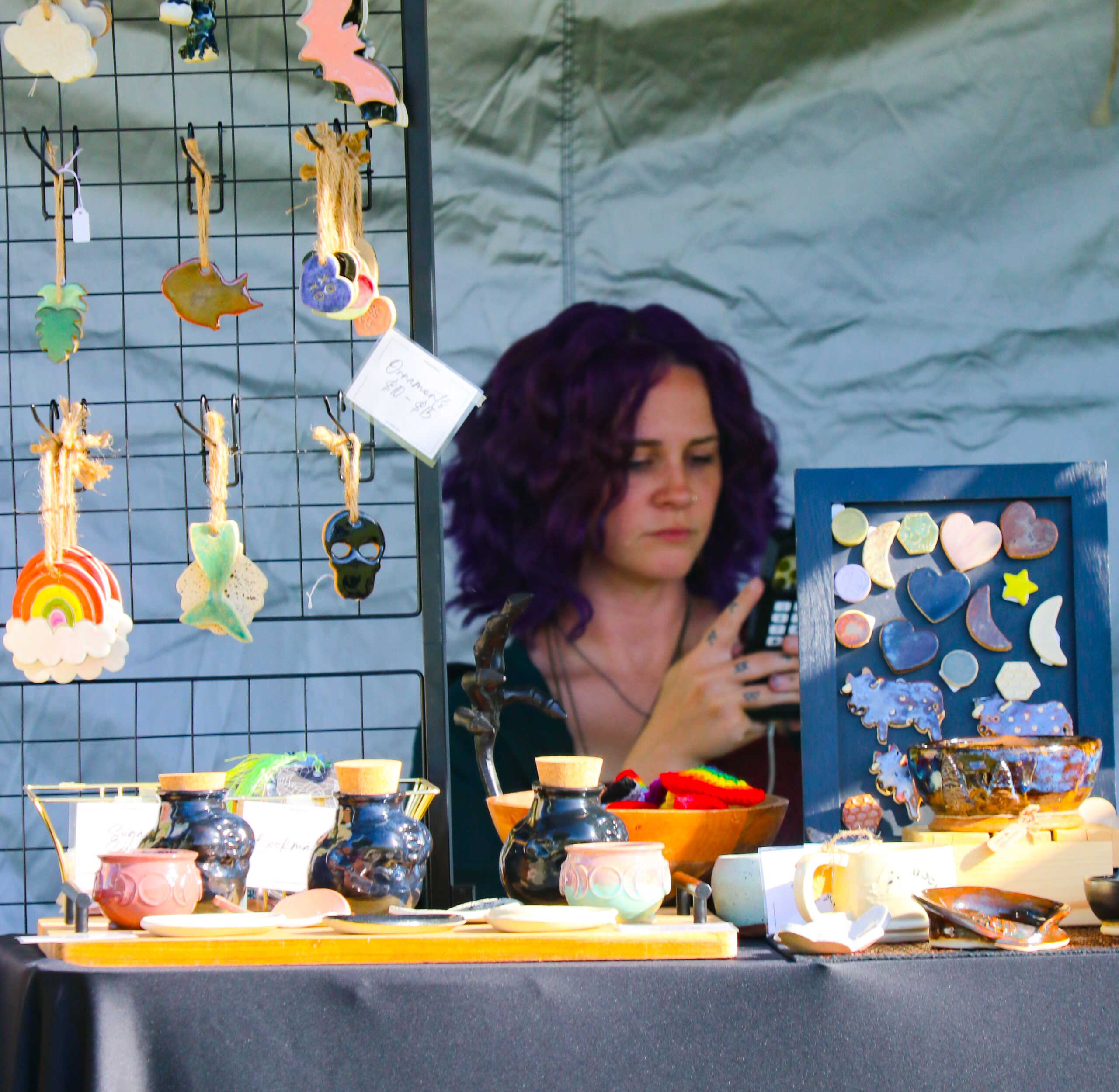 Ceramic art display at outdoor market stall.
