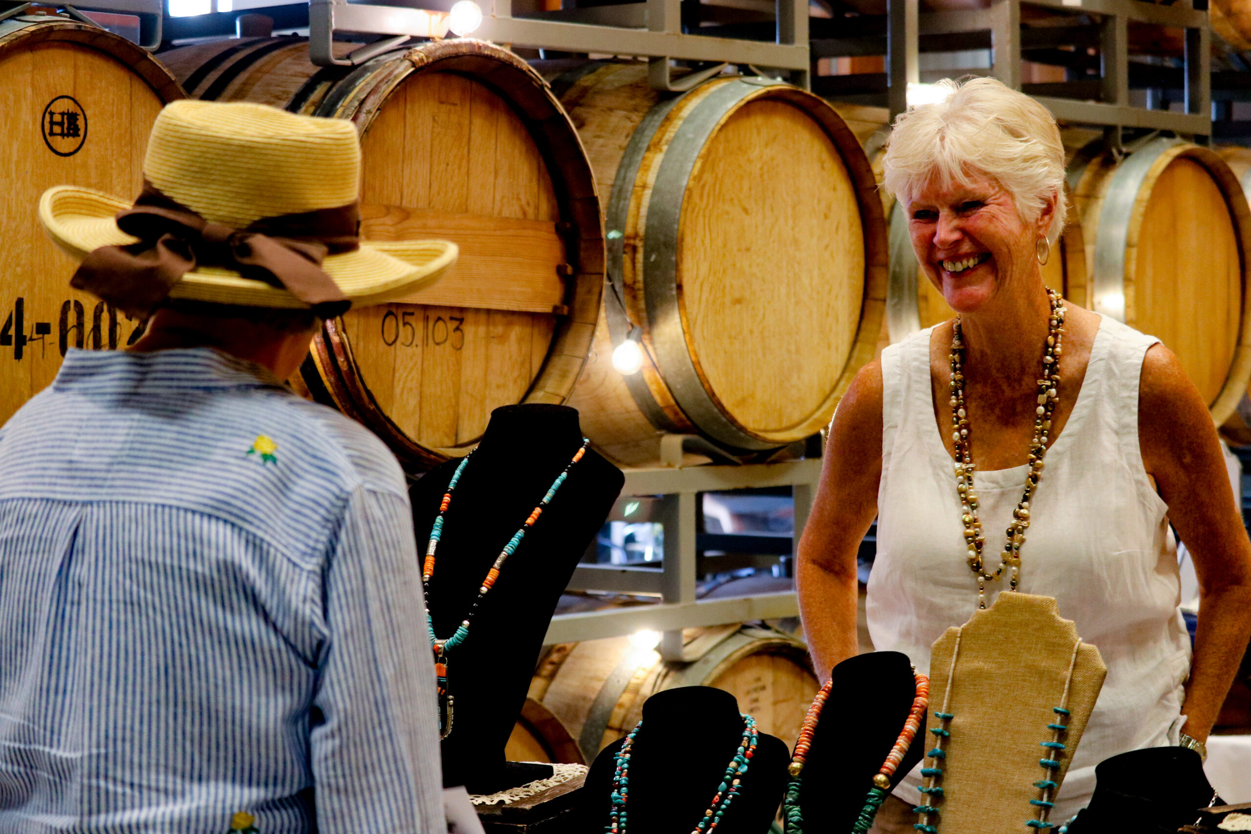 Woman selling jewelry at a winery
