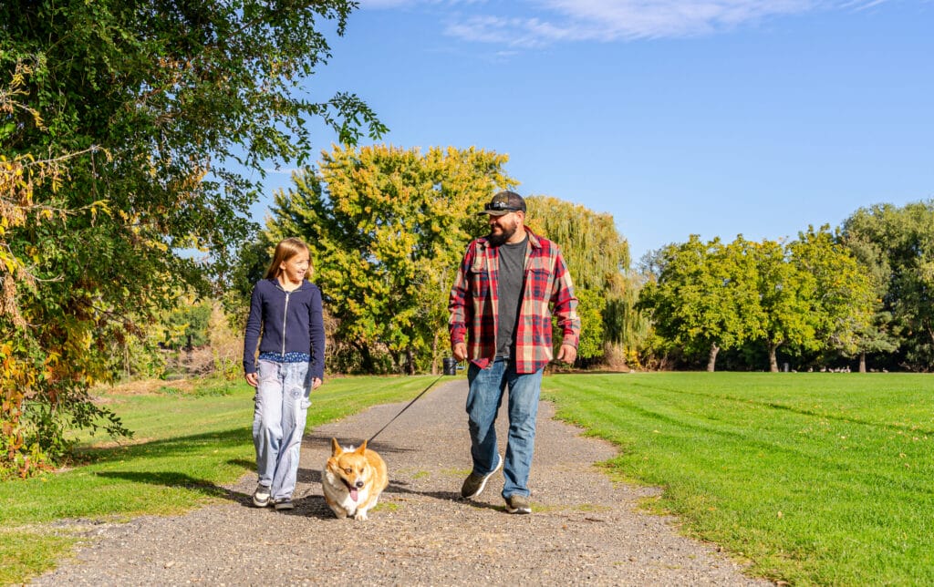 People walking dog on park path
