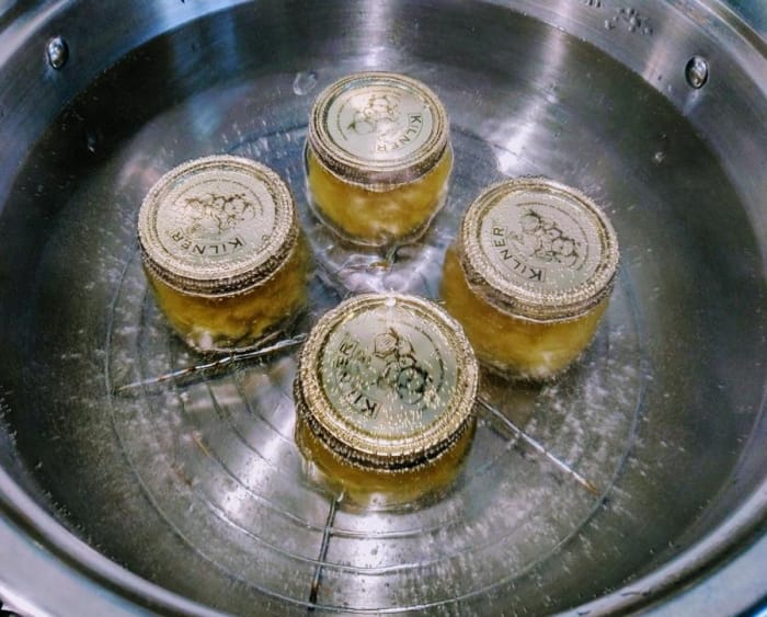Jars in water bath for canning process.