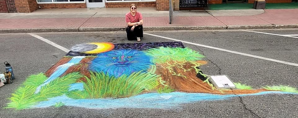 Colorful street chalk art with blue lion.