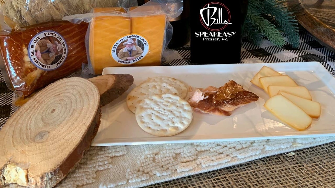 Smoked cheese, crackers, and salmon on platter.