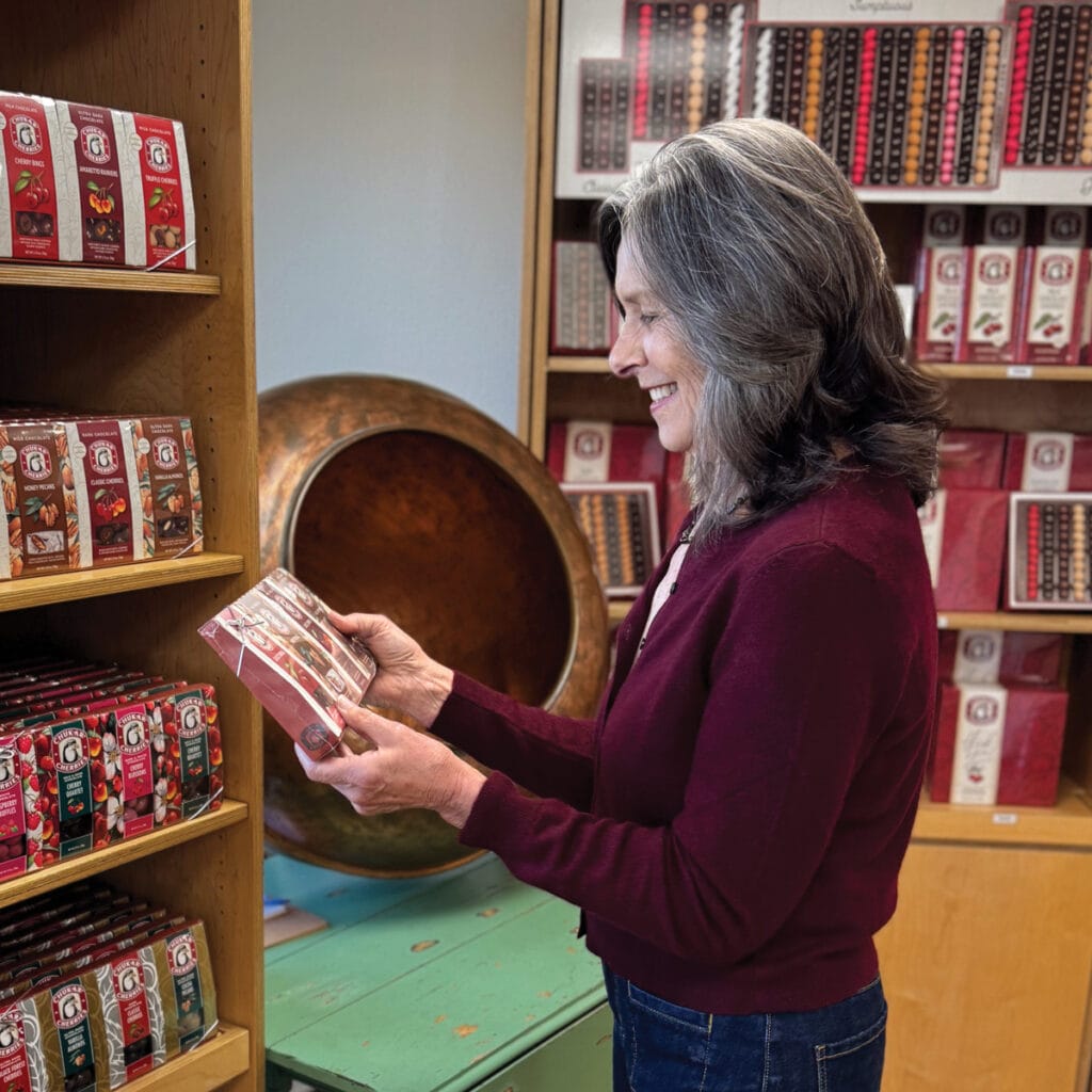 Woman shopping for packaged snacks in store.