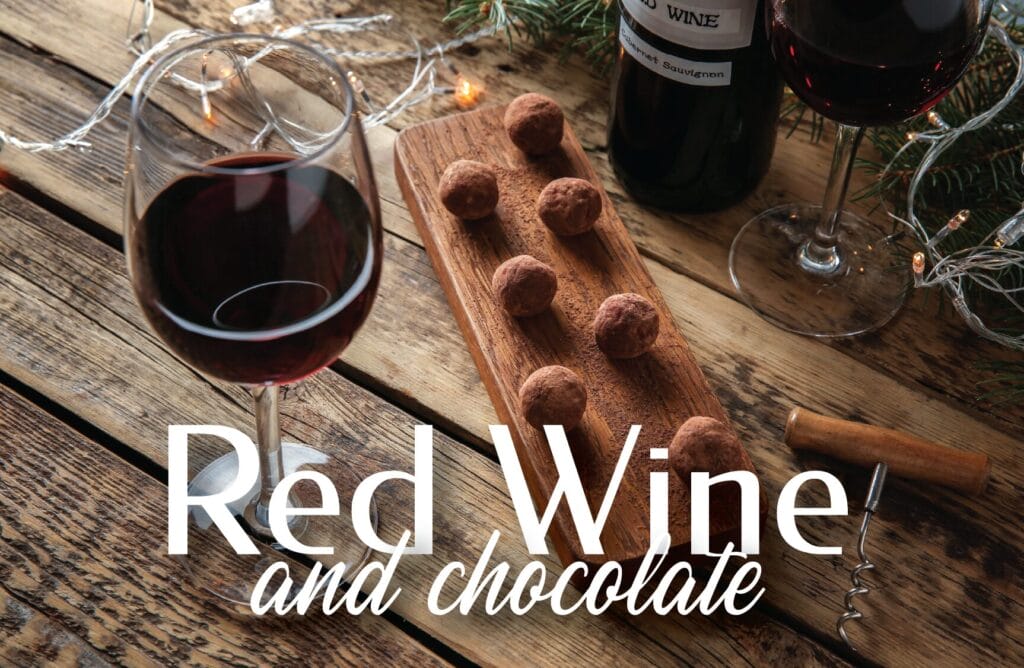 Red wine and chocolate on wooden table
