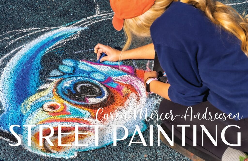 Artist creating vibrant street painting