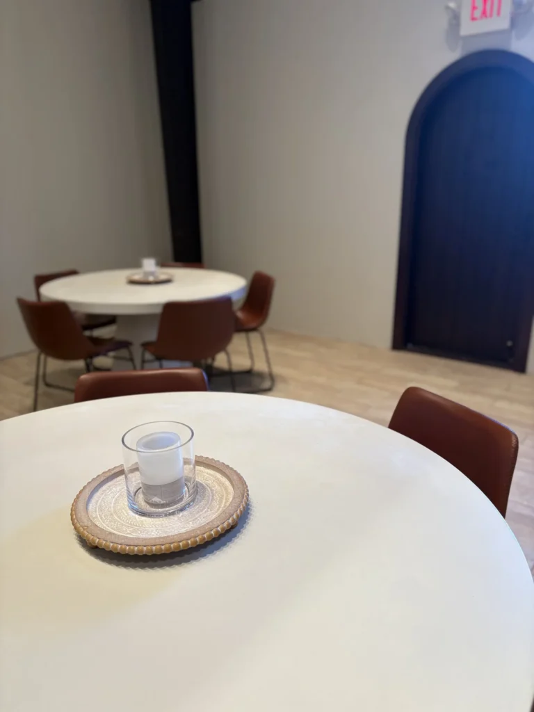 Cafe tables with candles and chairs.