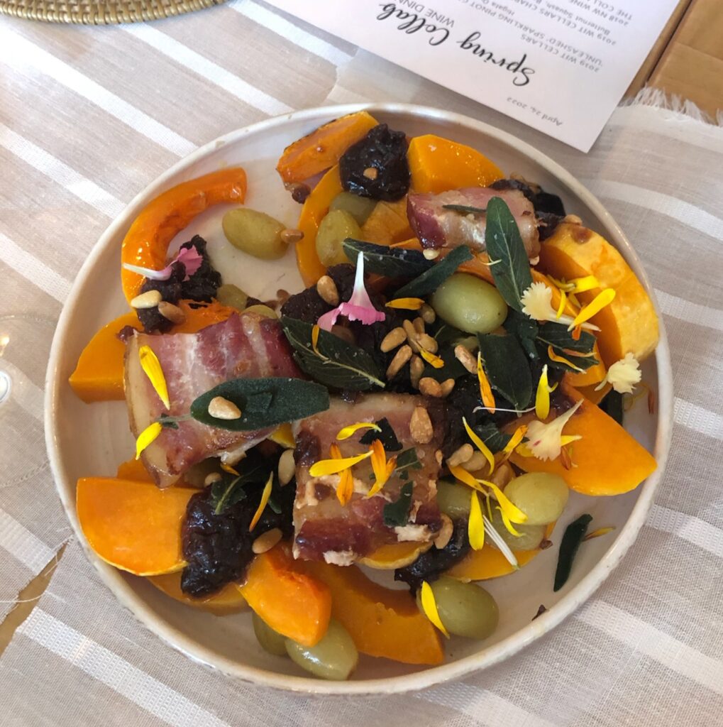 Colorful autumn salad with bacon and edible flowers.