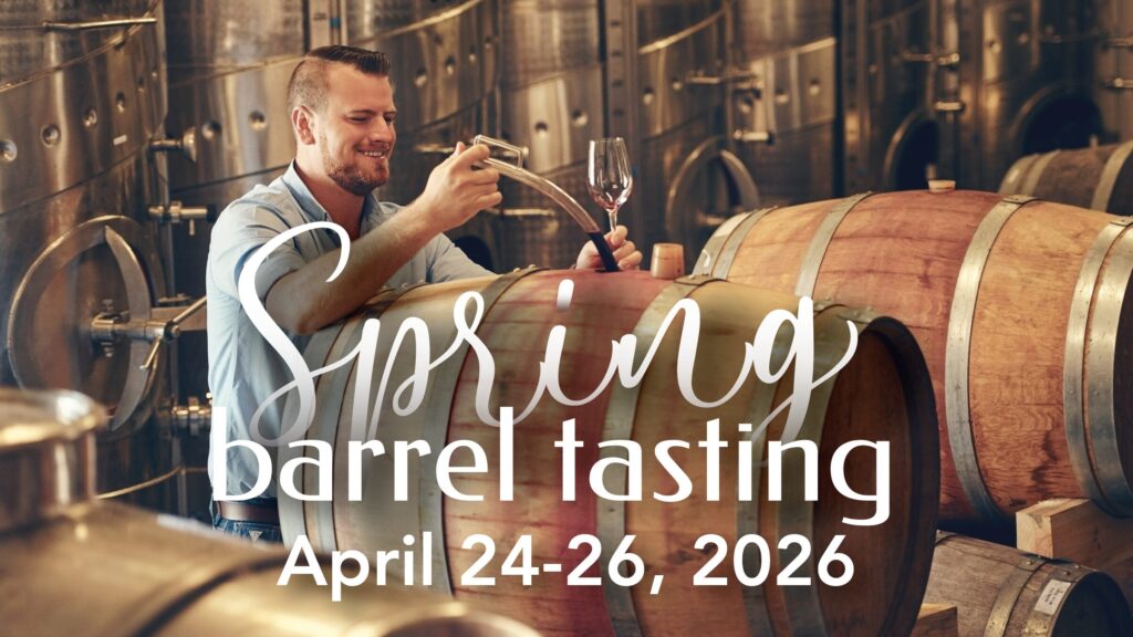 Man sampling wine from barrels at spring event.