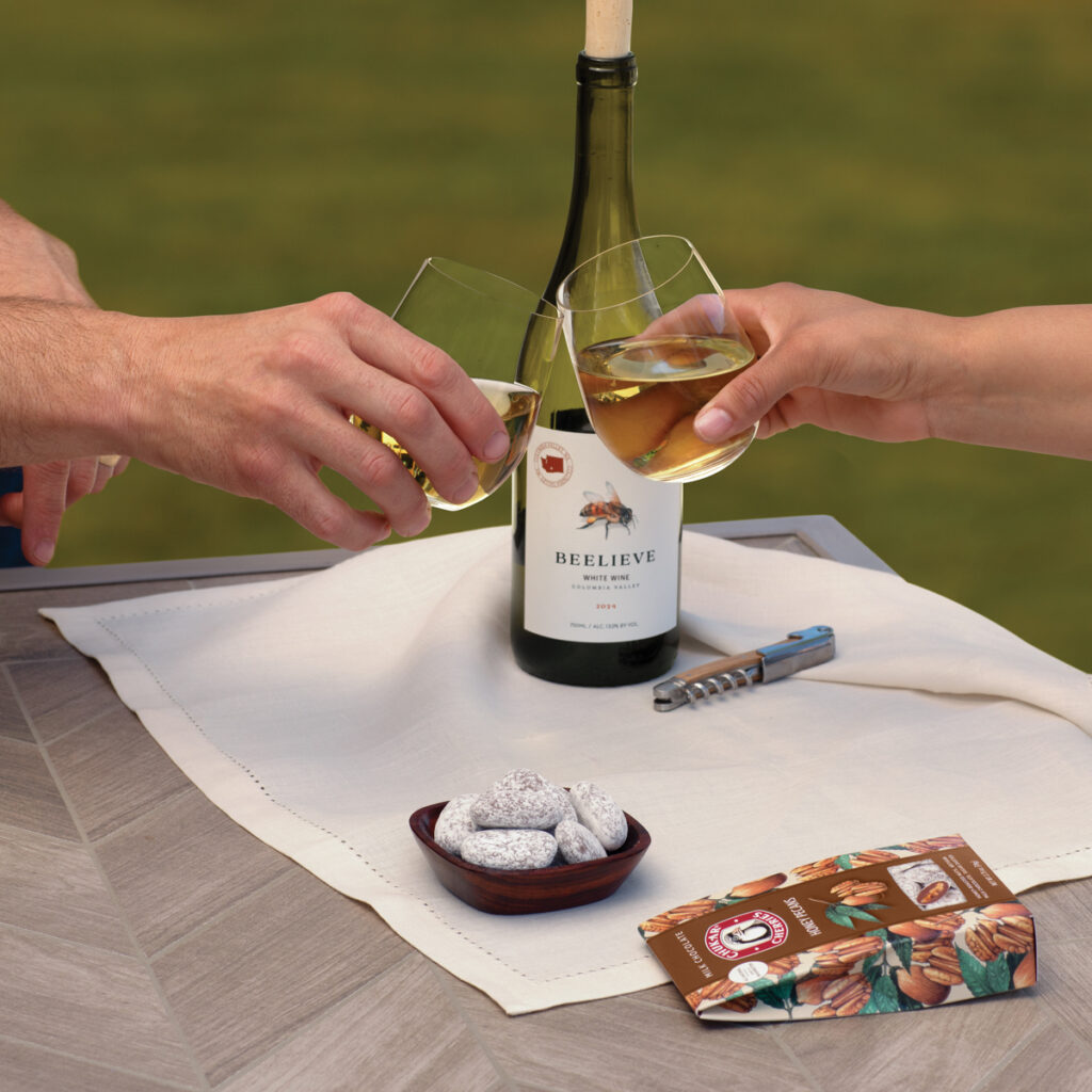 Wine glasses clinking over a table setup.