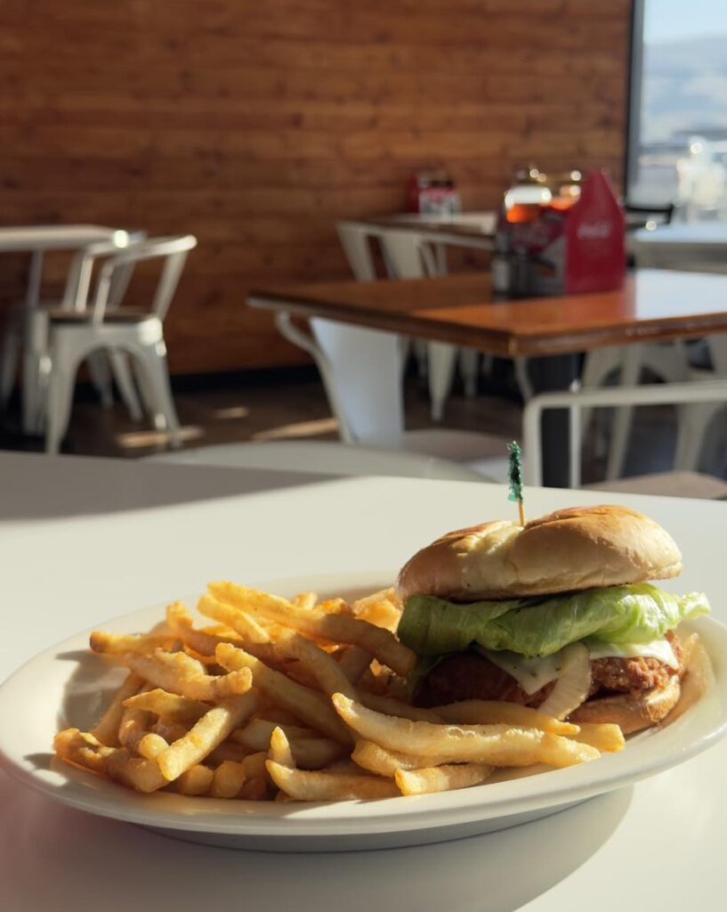 Cheeseburger with fries on restaurant table