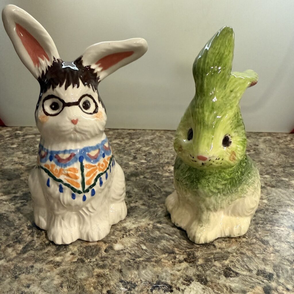 Two ceramic rabbit figurines on countertop