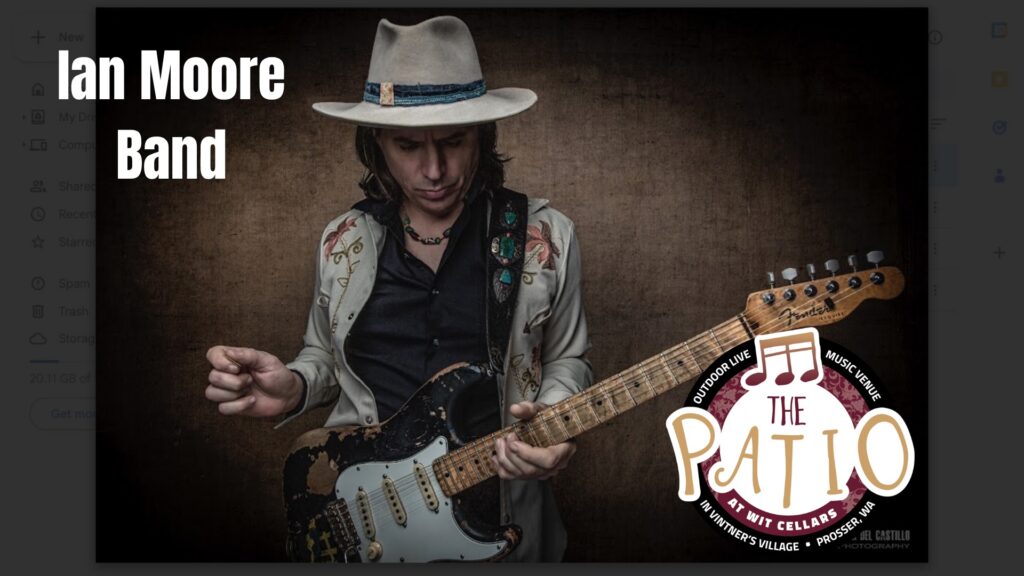 Musician playing electric guitar with Ian Moore Band text