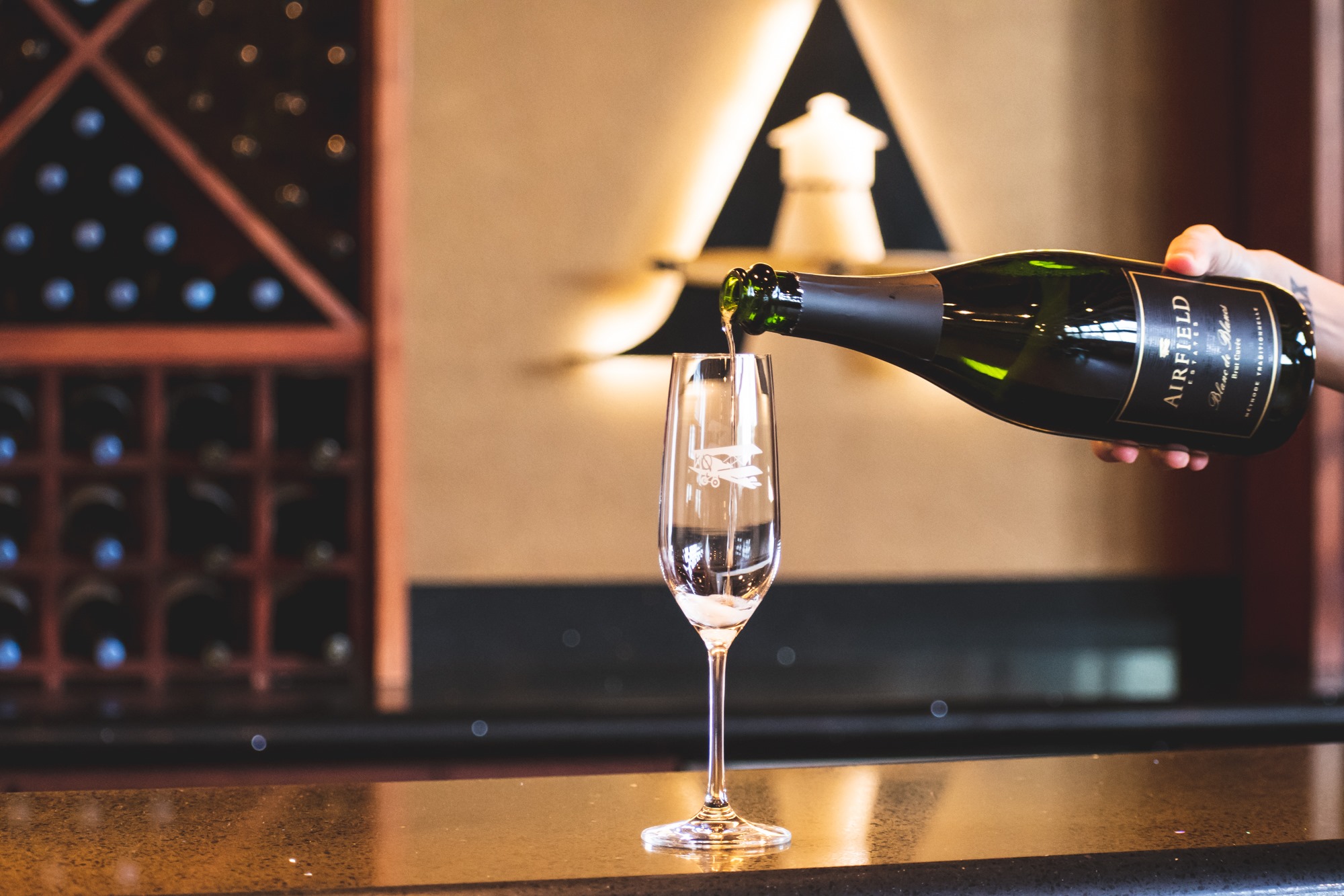 Champagne poured into a flute at a wine bar