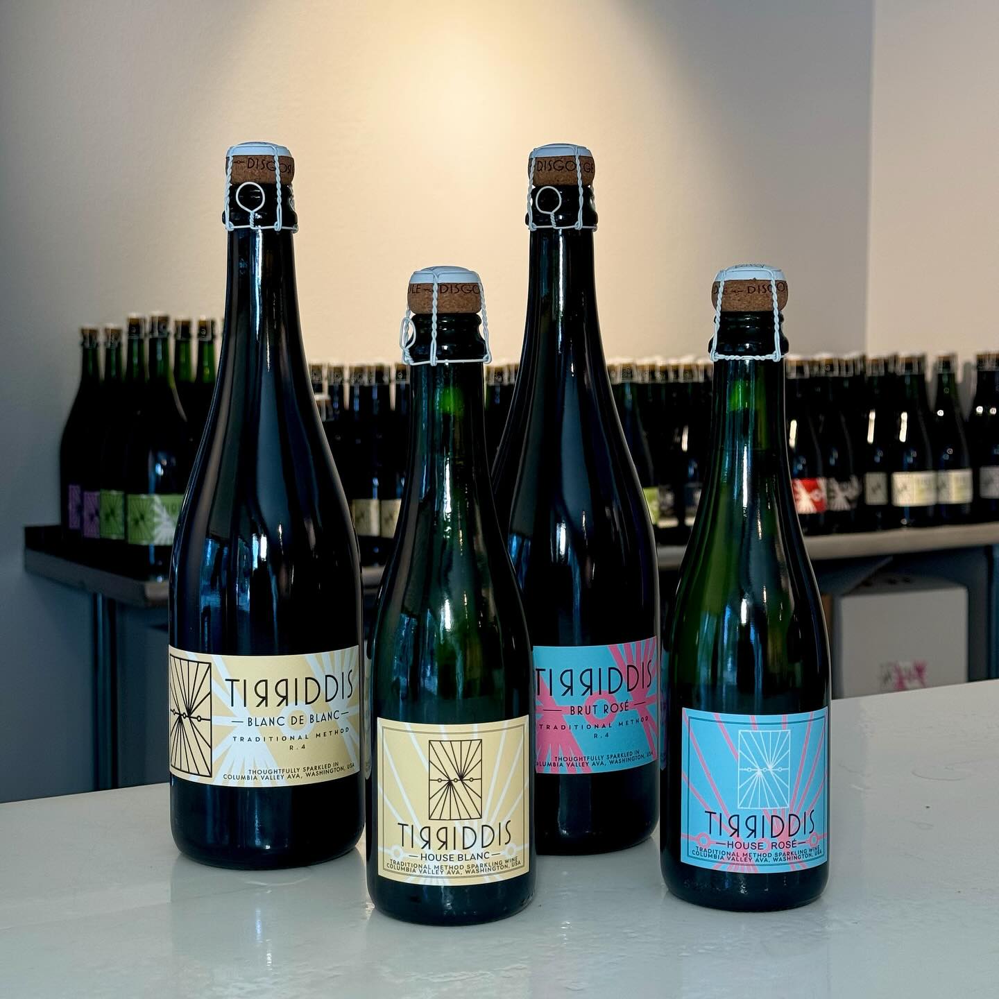Four Tirridis sparkling wine bottles with cork closures