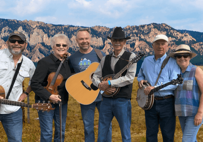 Flat Possum Pickers band with instruments outdoors.