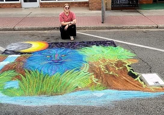 Colorful street chalk art with blue lion.