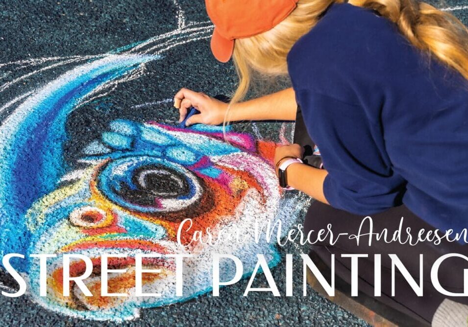 Artist creating vibrant street painting