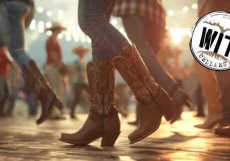 Group line dancing wearing cowboy boots at event.