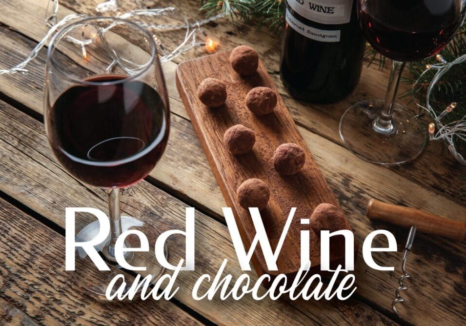 Red wine and chocolate on wooden table