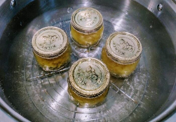 Jars in water bath for canning process.