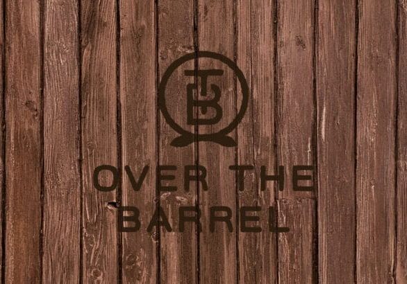 Wooden planks with 'Over the Barrel' logo